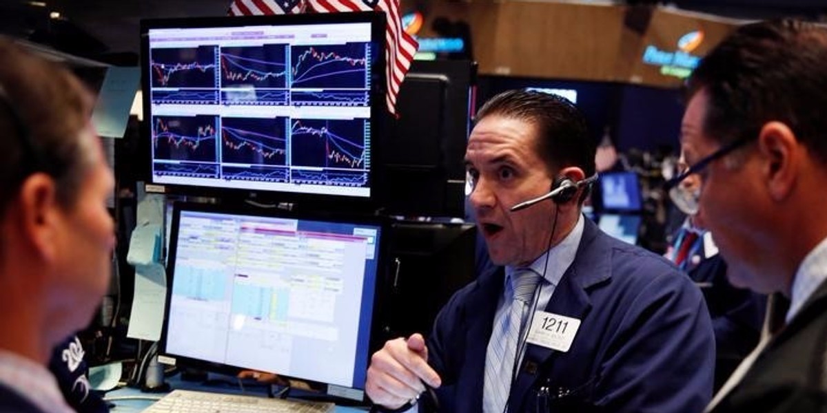 Traders work on the floor of the New York Stock Exchange (NYSE)