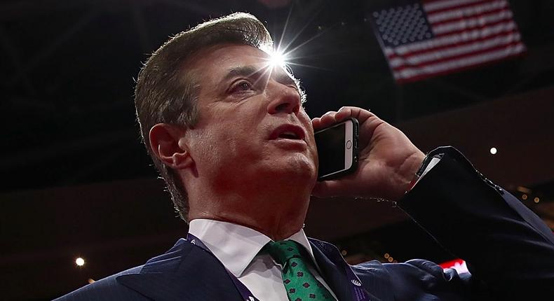 Paul Manafort, Campaign Manager for Donald Trump, speaks on the phone while touring the floor of the Republican National Convention at the Quicken Loans Arena as final preparations continue July 17, 2016 in Cleveland, Ohio.