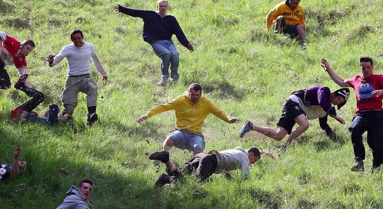 Contestants in the men's race chase a cheese down the steep gradient of Cooper's Hill during the annual Bank Holiday tradition of cheese-rolling on May 27, 2013 in Brockworth, Gloucestershire, England.