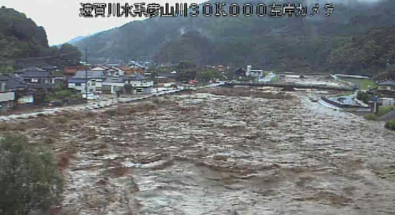 Roiling waters are sweeping through towns and villages in southwestern Japan, with at least 15 people reported missing