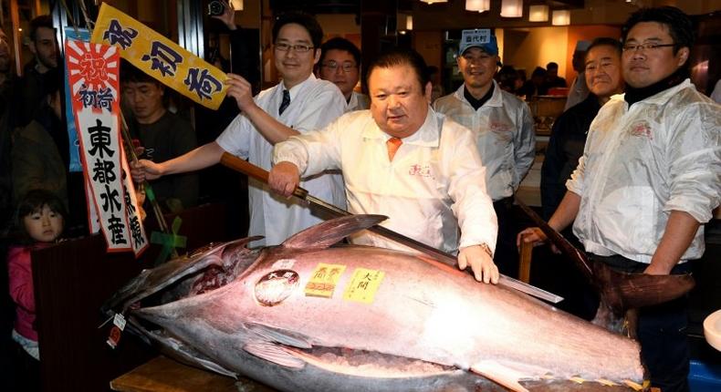 Kiyoshi Kimura (C), president of sushi restaurant chain Sushi-Zanmai, has paid $636,000 for a 212-kilogramme blue fin tuna on the first trading day of 2017 at Tsukiji fish market