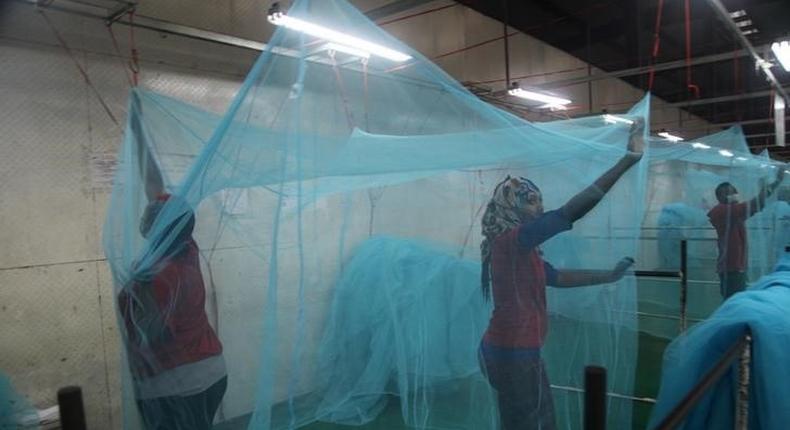 Workers look for holes in mosquito netting at the A to Z Textile Mills factory producing insecticide-treated bednets in Arusha, Tanzania, May 10, 2016. 