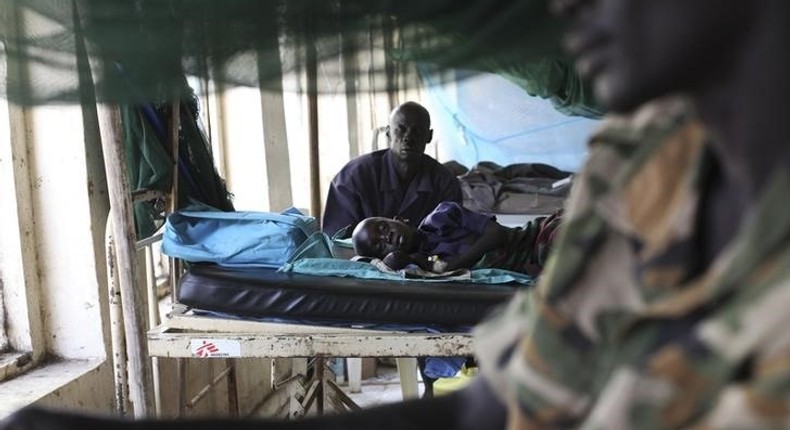 A child sick with malaria and from malnutrition lies on a bed in a hospital in Bor March 15, 2014. REUTERS/Andreea Campeanu