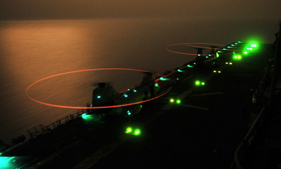 CH-46 Sea Knight helicopters assigned to the Evil Eyes of Marine Medium Helicopter Squadron 163 refuel on the flight deck aboard the amphibious-assault ship USS Boxer during night-flight operations.