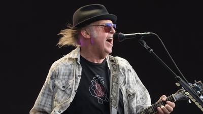 Neil Young performing live on stage in Hyde Park in London