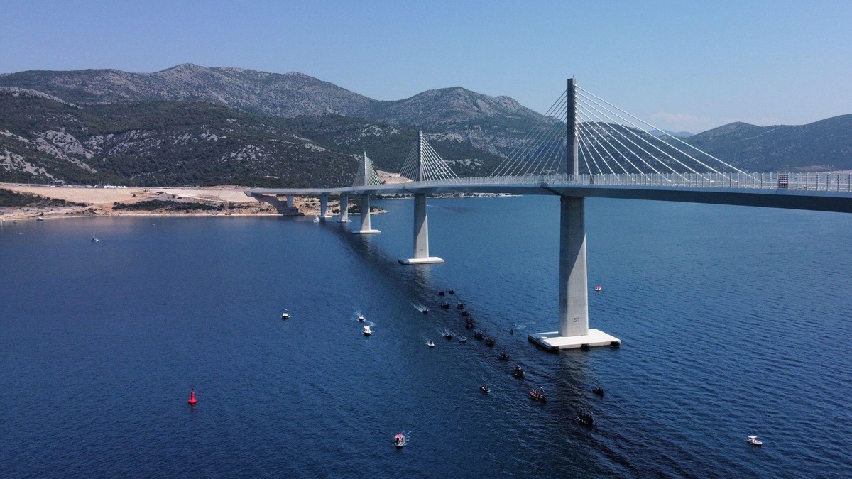 Brijesta, Croatia, July 26, 2022. Aerial view of the traditional race of Neretva Boats under Peljeski Bridge has been held as part of the bridge opening program in Brijesta, Croatia on July 26, 2022. 2.404 meters long bridge is constructed in 4 years by C