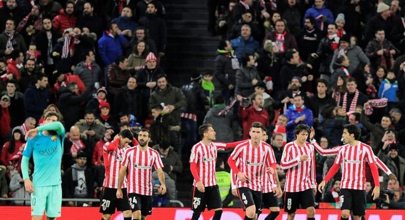 Athletic Bilbao's players celebrate after Athletic Bilbao's forward Aritz Aduriz scored his team's first goal during the Spanish Copa del Rey round of 16 first leg match against FC Barcelona at the San Mames stadium in Bilbao on January 5, 2017