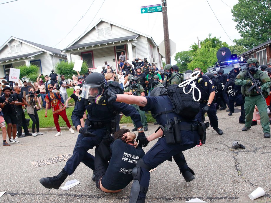 Police scuffle with a demonstrator as they try to apprehend him during a rally in Baton Rouge, Louisiana U.S. July 10, 2016.