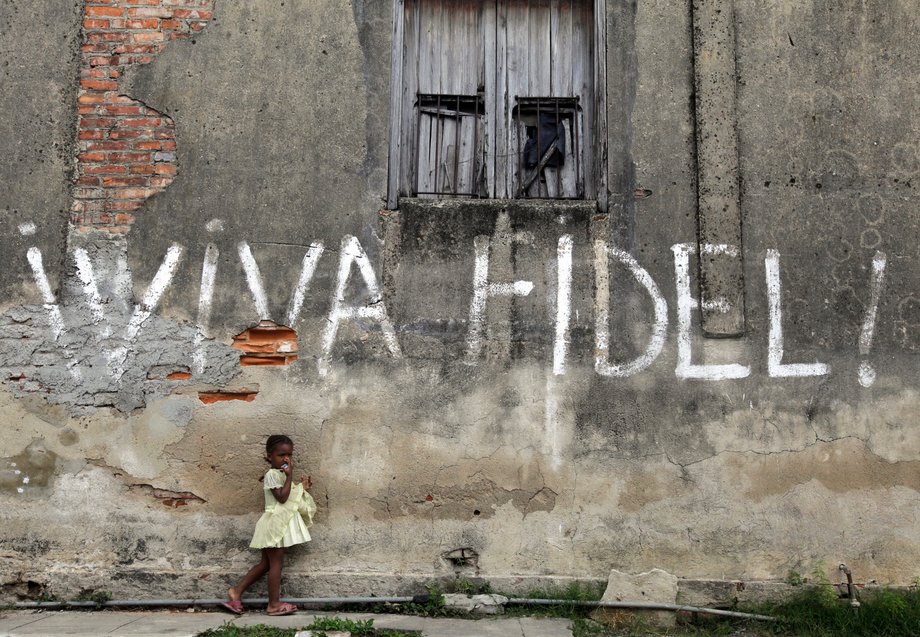 A girl stands next to graffiti that reads "Viva Fidel" (Long live Fidel), in Cuba's western province of Pinar del Rio February 23, 2010.