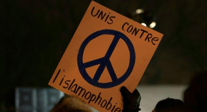 A person holds a sign United against Islamophobia during a rally near the Islamic Cultural Center in Quebec City, Canada on January 30, 2017