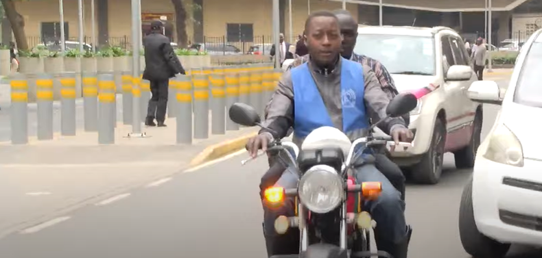Peter Omosa ferrying a passenger in Nairobi