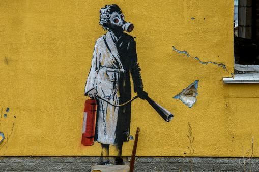Graffiti Banksy'ego na elewacji zniszczonego budynku w Hostomelu