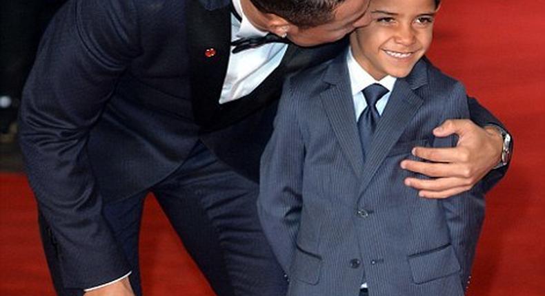 Cristiano Ronaldo kisses his son on the red carpet of his film premiere