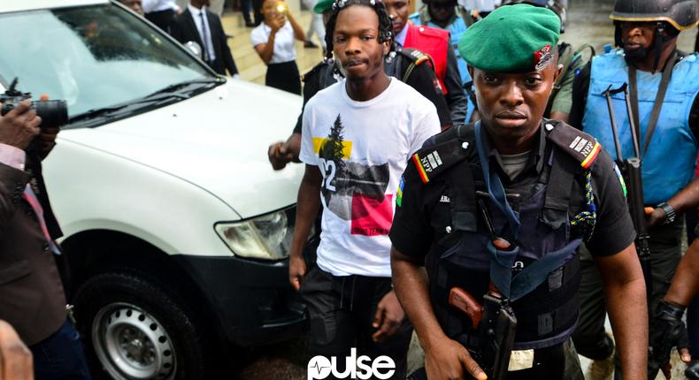 Naira Marley being escorted to the court during his trial in 2019 [PULSE]