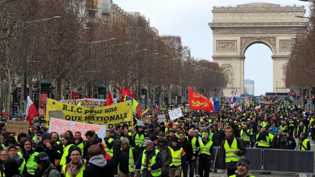 Protesters wearing yellow vests take part in a demonstration by the yellow vests movement in Paris