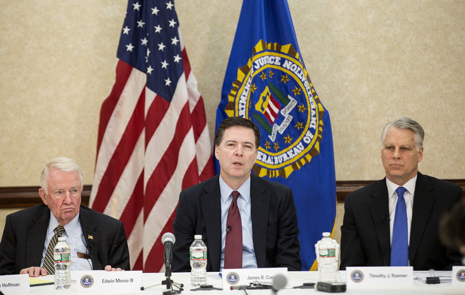 Comey (center) and Commissioners Edwin Meese III (left), and Timothy J. Roemer during a news conference on the release of the 9/11 Review Commission report in Washington, DC, on March 25, 2015. The FBI needs to strengthen its intelligence programs and information-sharing to counter the diverse and fast-moving national threats that have evolved since the September 11, 2001, attacks, a congressional commission said at the time.