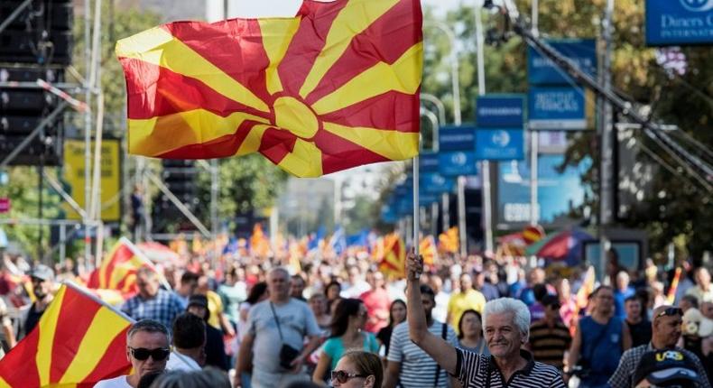 People wave Macedonian flags at a yes campaign rally in Skopje ahead of the referendum on whether to change the country's name to Republic of Northern Macedonia