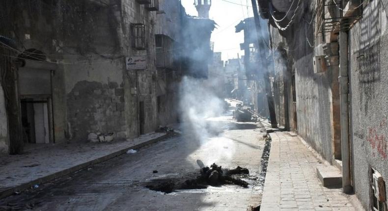 The charred body of a rebel fighter lies on a street in the Bab al-Hadid neighbourhood, in Aleppo's Old City