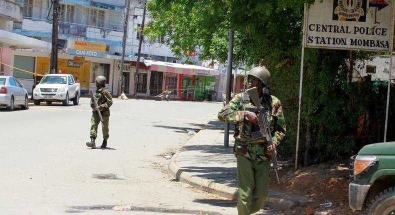 Armed policemen walk outside the central police station after an attack, in the coastal city of Mombasa, Kenya, September 11, 2016. 