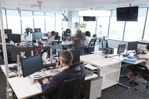 Interior Of Busy Modern Open Plan Office With Staff