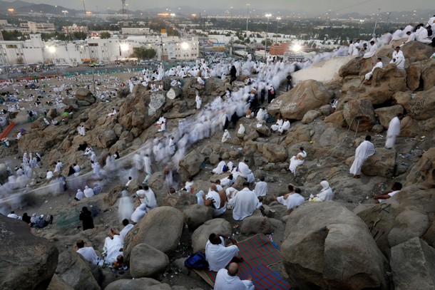 Muslim pilgrims gather on Mount Mercy on the plains of Arafat during the annual haj pilgrimage, outs