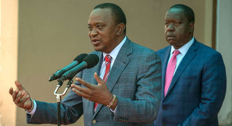 File image of interior CS Fred Matiangi with President Uhuru Kenyatta