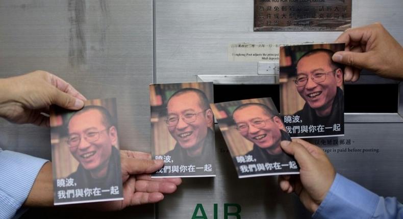 Chinese Nobel laureate Liu Xiaobo (pictured on cards) was sentenced in 2009 for 'subversion'