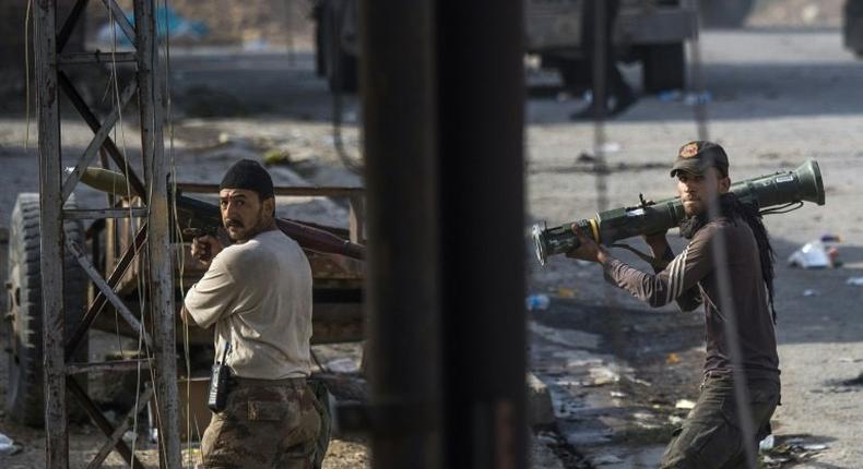 Soldiers from the Iraqi Special Forces 2nd division carrying rocket propelled grenades (RPG) and anti tank missiles take up positions to prepare for a reported suicide bomb vehicle in Mosul's Karkukli neighbourhood, on November 14, 2016