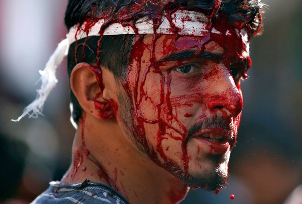 A Kashmiri Shi'ite Muslim bleeds after he flagellated himself during a Muharram procession to mark A