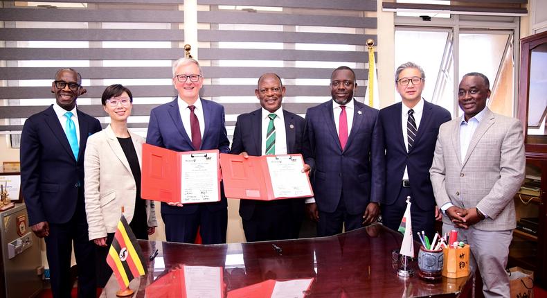 The Vice Chancellor Prof. Barnabas Nawangwe (Centre) and UWO President Dr. Alan Shepard (3rd Left) show off the signed MoU as Left to Right: UWO's Dr. Opiyo Oloya and Dr. Lily Cho as well as University Secretary Yusuf Kiranda, UWO's Dr. John Yoo and Head of Advancement Awel Uwihanganye witness on March 21.