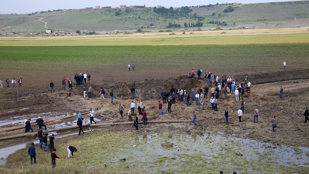 People gather at the site of last night's explosion near the Kurdish-dominated southeastern city of Diyarbakir