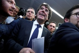 Sacked Catalan leader Carles Puigdemont departs after a news conference in Brussels