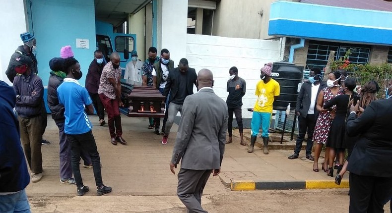 Ruth Matete picks the remains of her late husband Beloved John from the KNH morgue