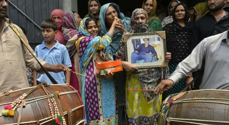 Relatives of Pakistani national Zulfiqar Ali, who was sentenced to death in 2005 for heroin possession, celebrate in Lahore after the Indonesian government halted his execution