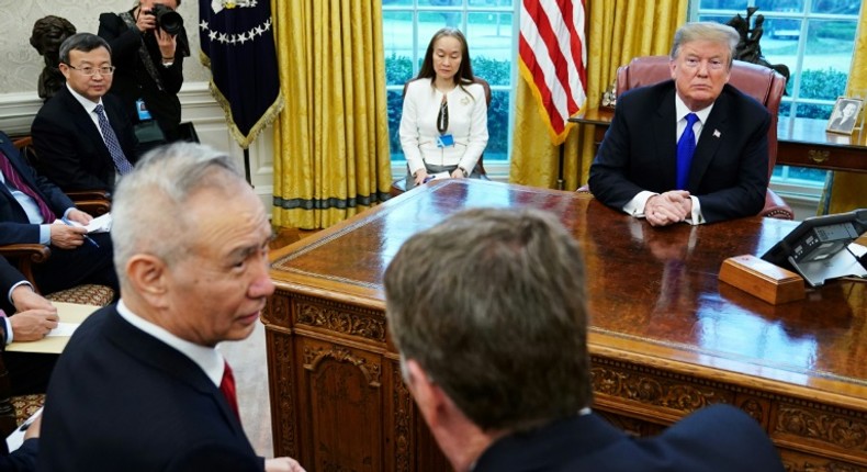 In this file photo taken on February 22, 2019 US President Donald Trump watches as China's Vice Premier Liu He (L) speaks with US Trade Representative Robert Lighthizer (R) in the Oval Office