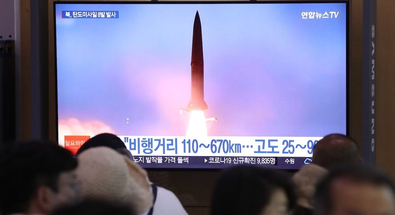 People watch a TV broadcast about a North Korean missile launch at the Seoul Railway Station, June 5, 2022.