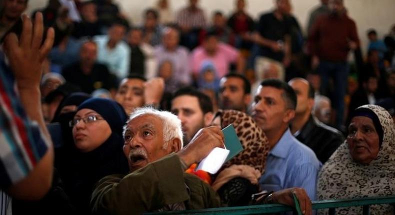 A man asks for a travel permit to cross into Egypt through the Rafah border crossing after it was opened for two days by Egyptian authorities, in the southern Gaza Strip May 11, 2016. 