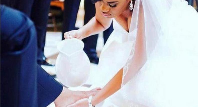 Bride washing her groom's feet