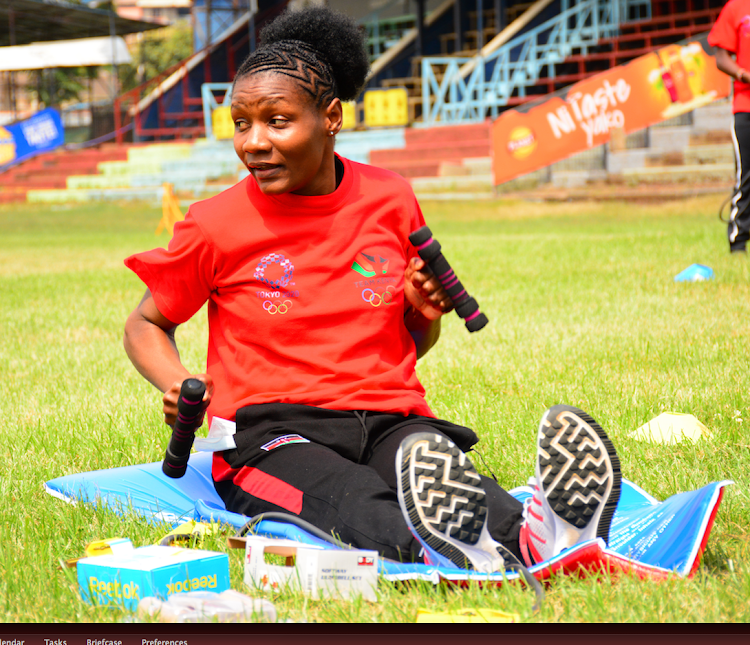 Faith Ogallo tries out the training kit donated by NOCK at the RFUEA grounds. 