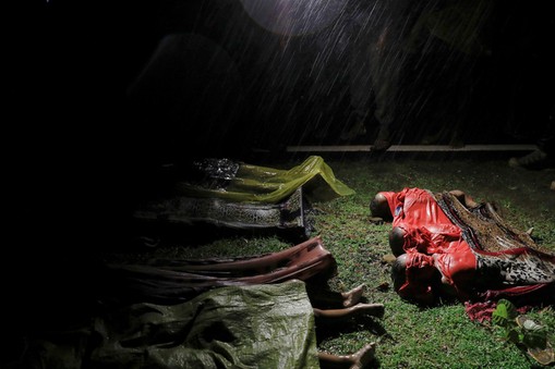 Bodies of children and other Rohingya refugees are covered after their boat with passengers fleeing from Myanmar capsized off the Inani beach near Cox's Bazar