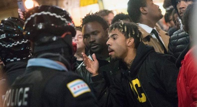 Rapper Vic Mensa confronts police during the protest