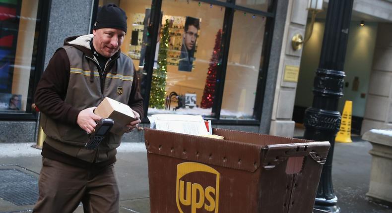 A UPS worker delivers packages on December 26, 2013 in Chicago, Illinois. Bad weather and a higher than expected demand from online sales caused FedEx and UPS to miss many Christmas delivery deadlines.