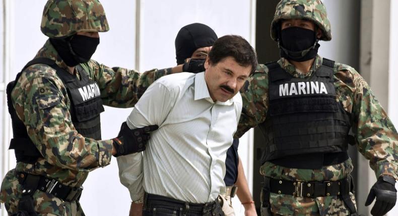 Joaquin El Chapo Guzman is escorted by marines as he is presented to reporters in Mexico City soon after his arrest in February 2014