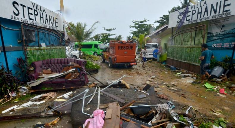 Debris from damaged buildings is strewn across a road in Carita after the area was hit by a tsunami following an eruption of the Anak Krakatoa volcano