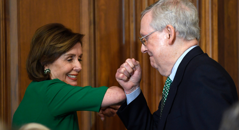 Nancy Pelosi and Mitch McConnell elbow bump