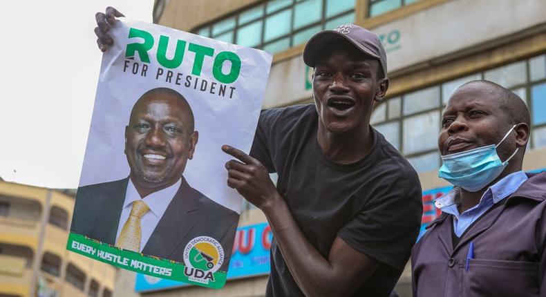 NAIROBI, KENYA - 2022/07/18: A Kenyan man holds a poster of the deputy president of Kenya and United Democratic Alliance (UDA) presidential candidate William Ruto during his campaign rally at the Gikomba market in Nairobi. (Photo by Boniface Muthoni/SOPA Images/LightRocket via Getty Images)