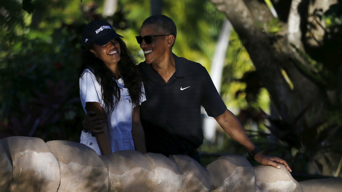 U.S. President Barack Obama laughs with his daughter Malia as they visit the Honolulu Zoo in Honolulu, Hawaii