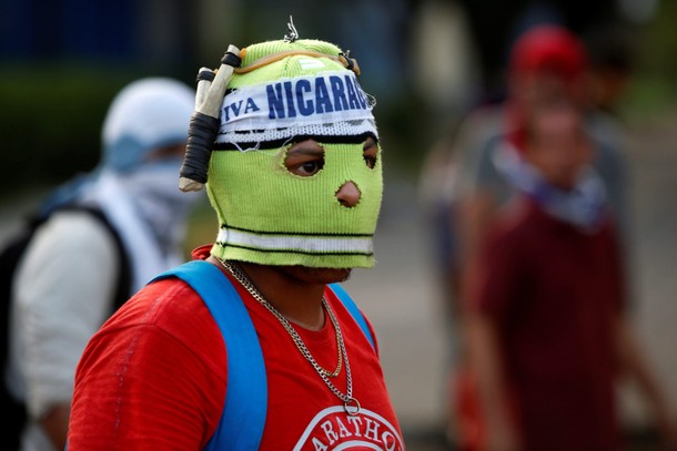 A masked protester is pictured during a protest against President Daniel Ortega's government in Leon