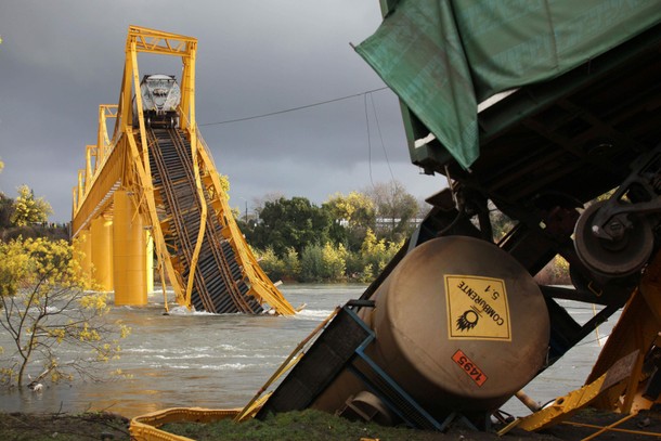 Wagons of a freight train are seen on the Tolten river after a bridge collapsed in Pitrufquen villag