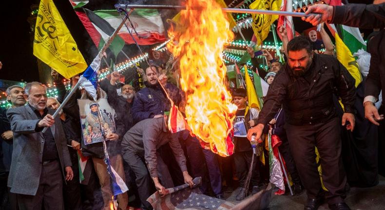 Iranian protesters are burning the U.S. flag and an Israeli flag during a protest gathering to condemn the Israeli airstrike against the Iranian consulate in Syria, at Palestine Square in Tehran, Iran, on April 1, 2024.Morteza Nikoubazl/NurPhoto via Getty Images